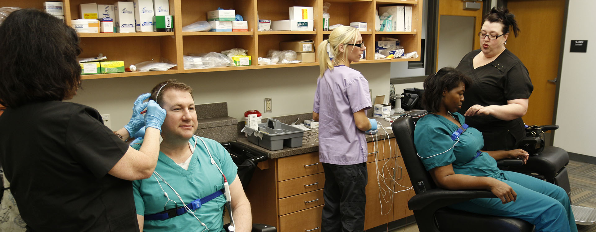 students applying diagnostic sensors to patients