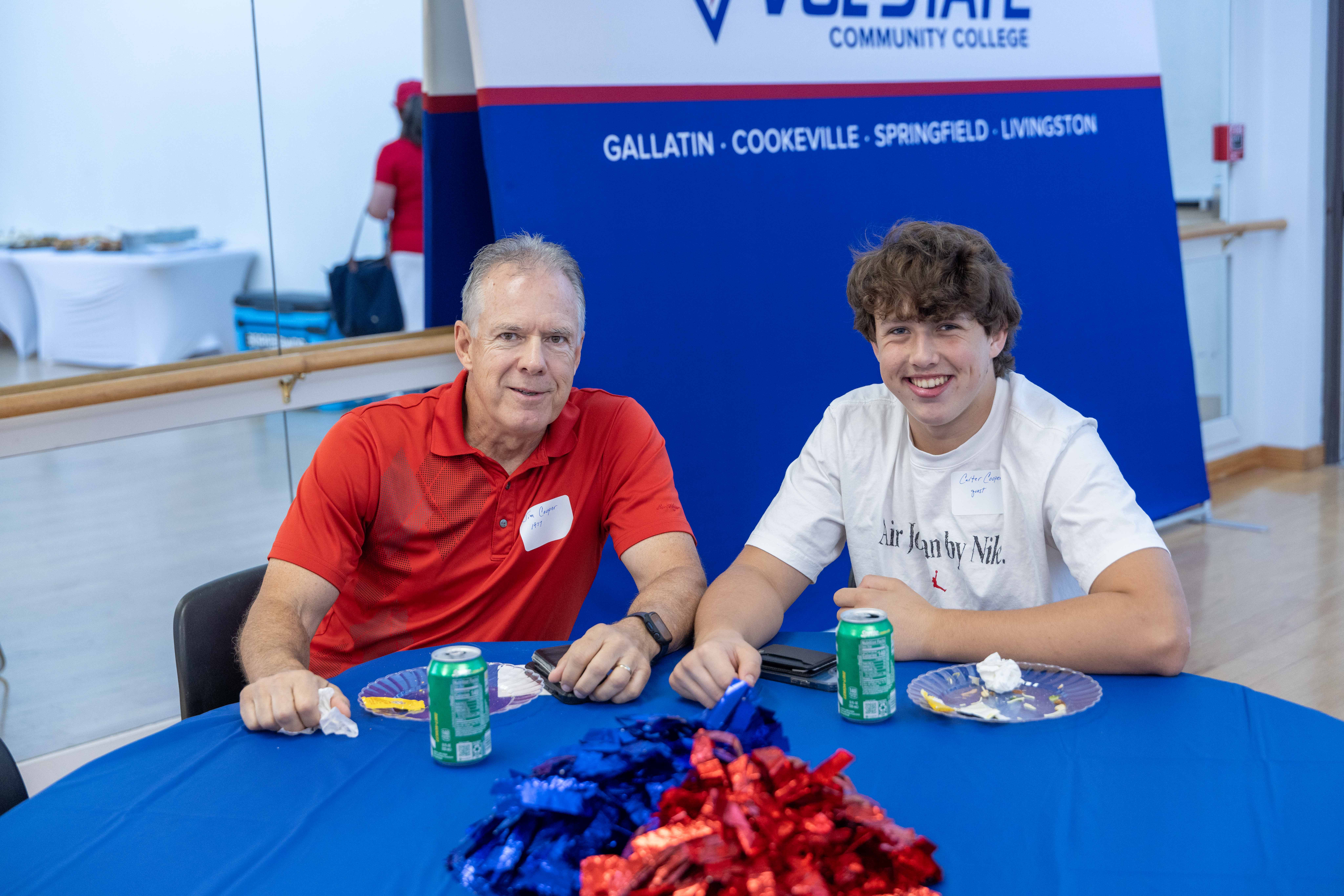 two male Vol State alumni enjoying a meal at a table