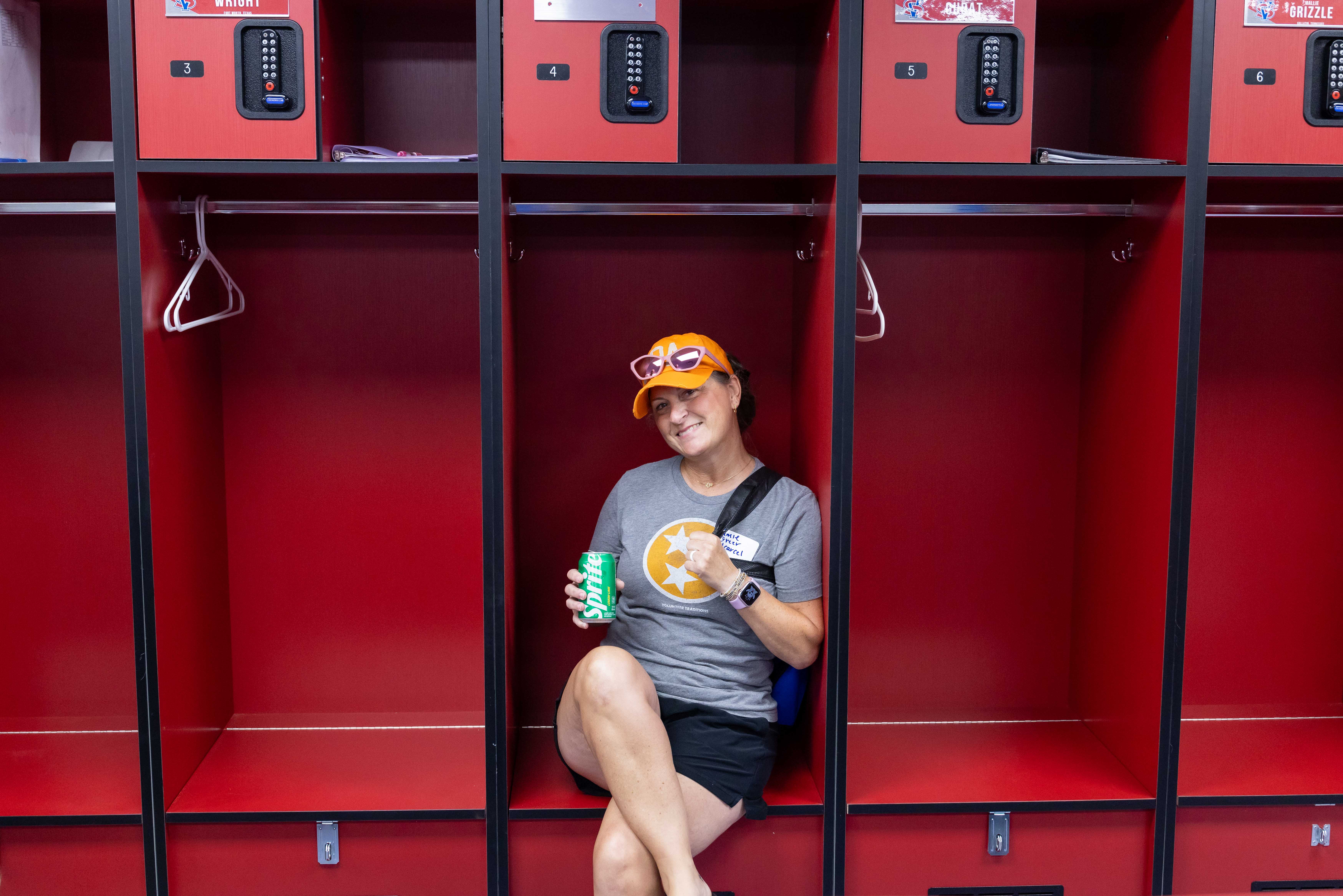 a female Vol State softball alumnus sitting in a stall in the locker room