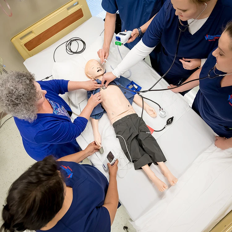 nursing students practicing on a mannequin