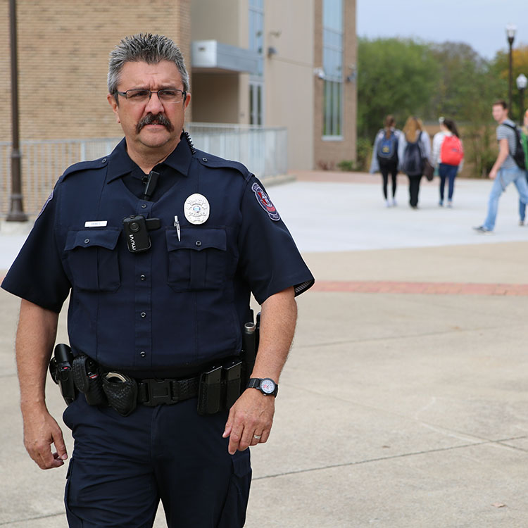 campus police officer walking on campus
