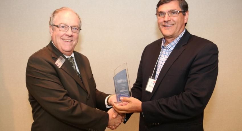 Dr. Jerry Faulkner presents the 2015 P-16 BEST award to local businessman Marius Sipos