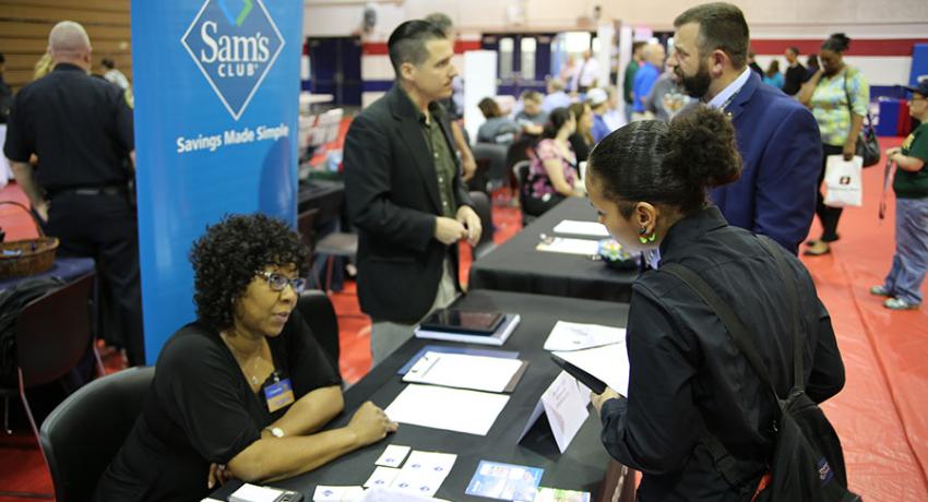 students speaking with recruiters at the career fair