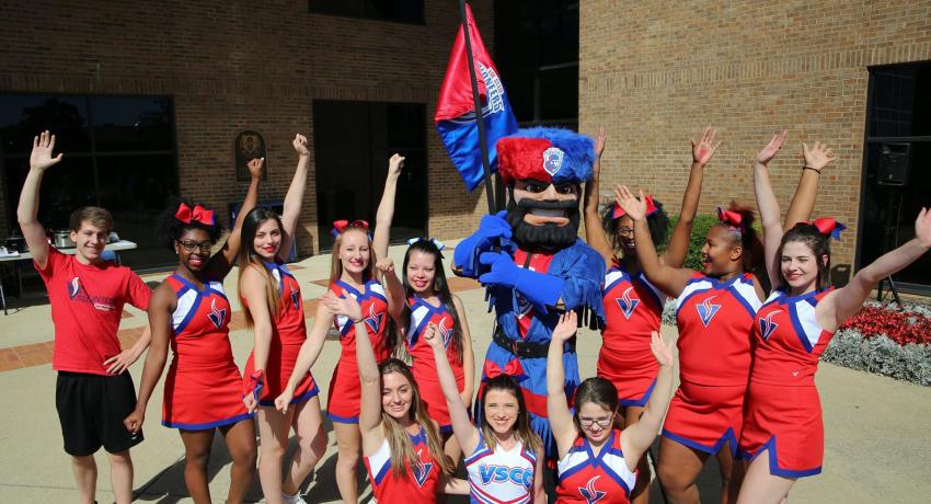 the new Pioneer mascot standing beside a group of Vol State cheerleaders