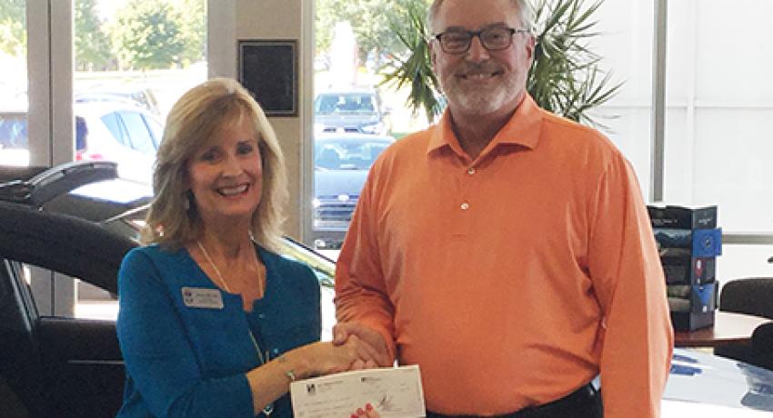 Ron Hibbard donating a check to the Foundation