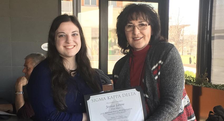 Vol State student Jessica Levine receives an award from Charlotte Speer with Sigma Kappa Delta.