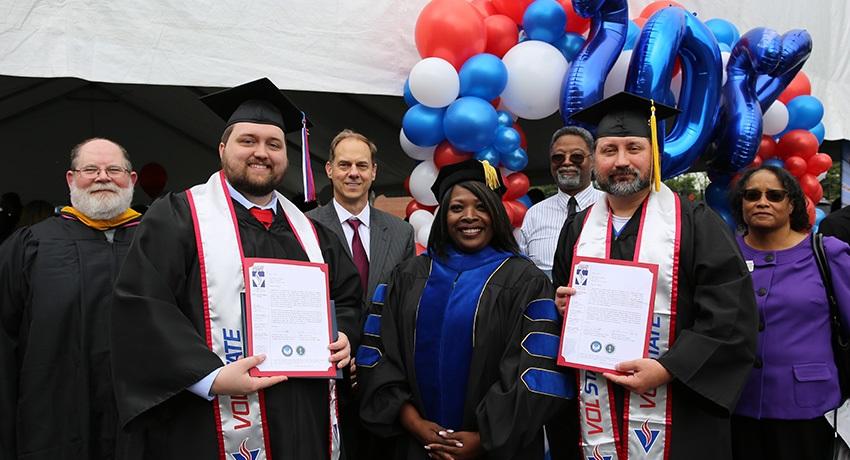 Vol State graduates Mike Massey, left, and Steven Gaebler, right, were recognized by college president, Dr. Orinthia Montague, center