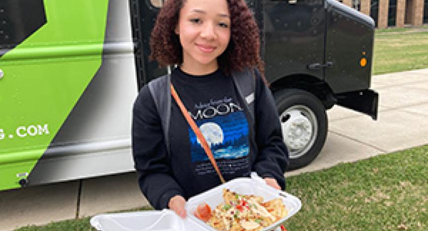 food truck customer showing her lunch