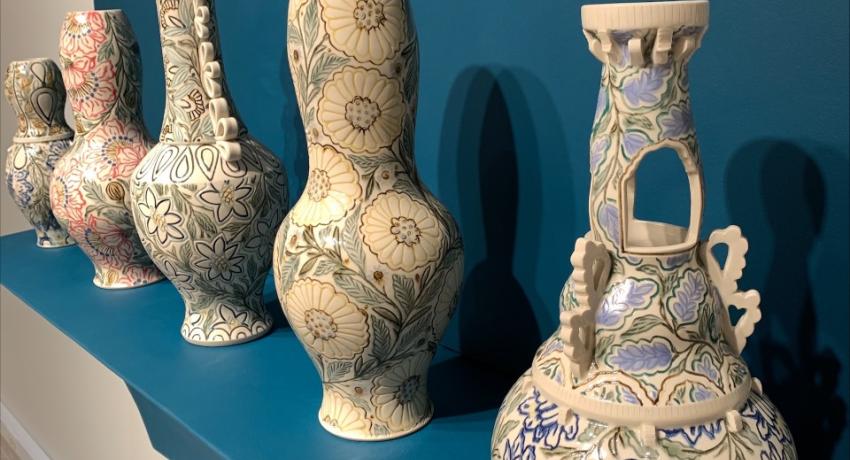 four clay pots on display