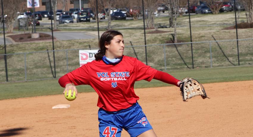 Softball player Grace Gregory about to throw the ball to home plate