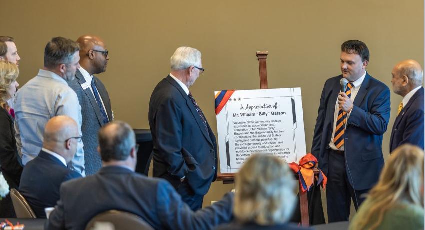 Nicholas Bishop, VP for Economic Development and the Regional Centers presents a gift to Mr. Billy Batson during today's event.  The piece represents the brass plaque that will be in place at Vol State Springfield as a show of appreciation. 