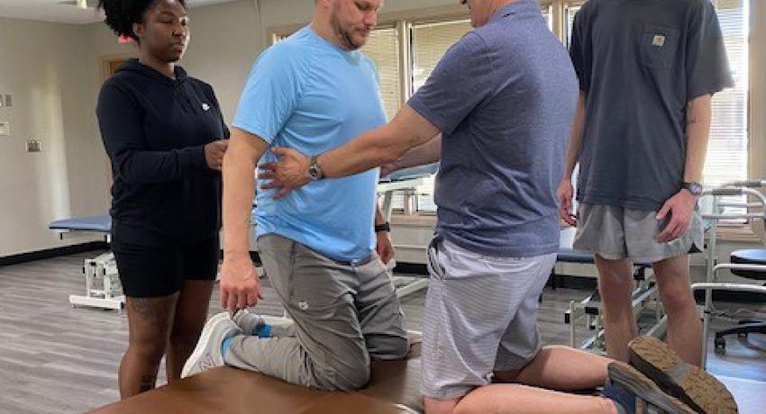 therapists helping a male, MS patient