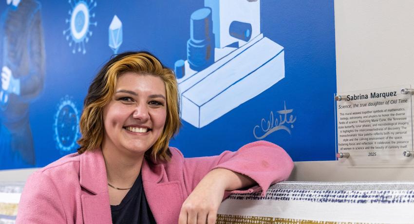 Vol State Art Student, Sabrina Marquez, posing next to her mural