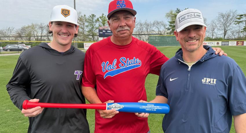 Former assistant coaches John Rypel and Bradyn Kail presented Coach McGuire with a commemorative #500 Old Hickory bat