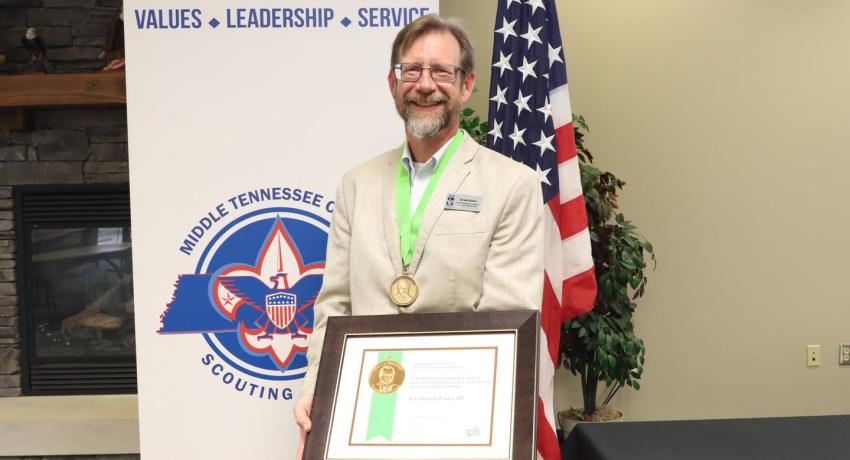 Professor of History Grady Eades celebrates his recent recognition with the Hillcourt Bronze Medal.