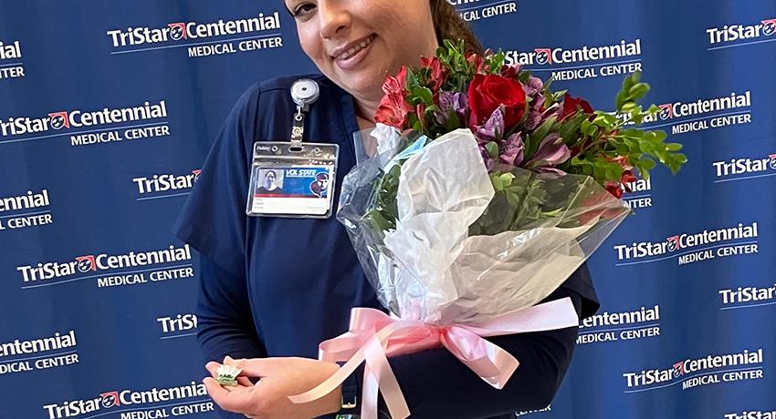 Jera holding a vase of roses