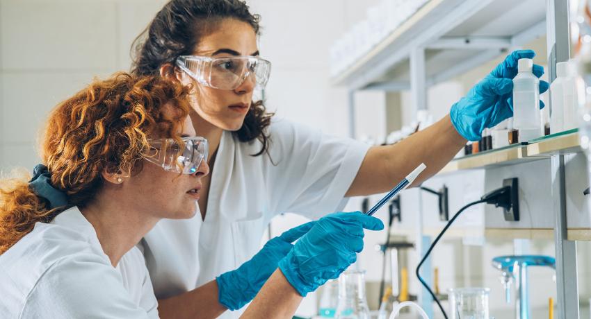two biotech students learning in a lab
