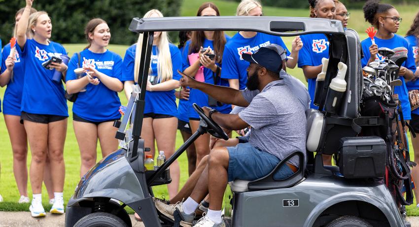 Members of the Vol State soccer team cheer on golfers as the event begins