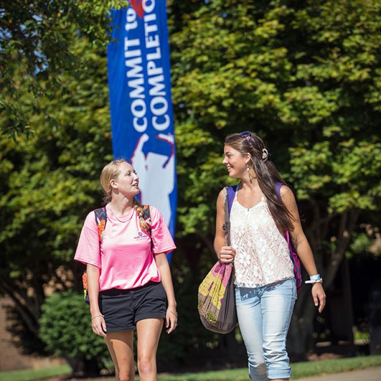 two female students walking across campus
