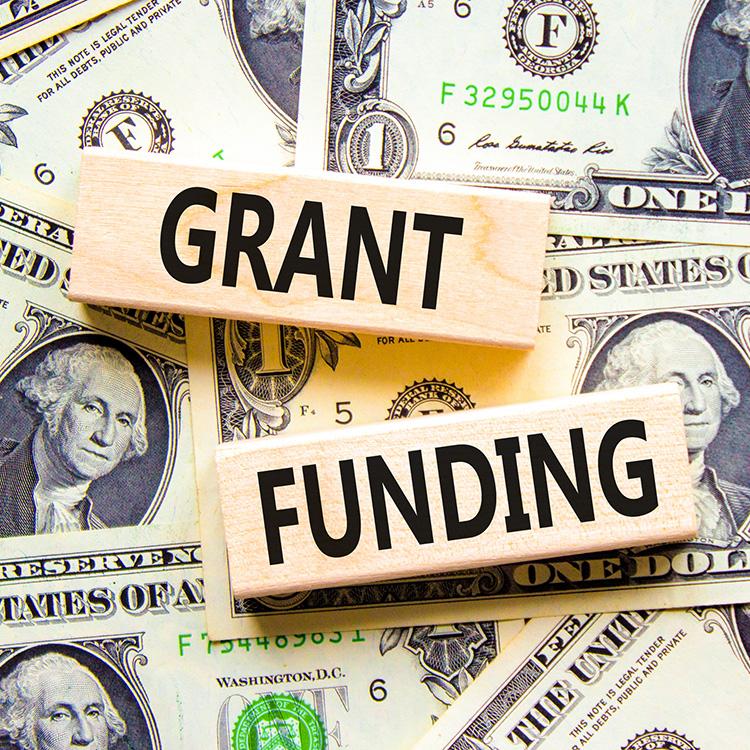 grant funding words on top of money