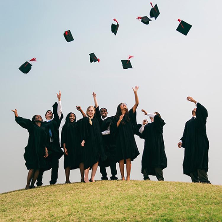 graduates tosses their caps in the air