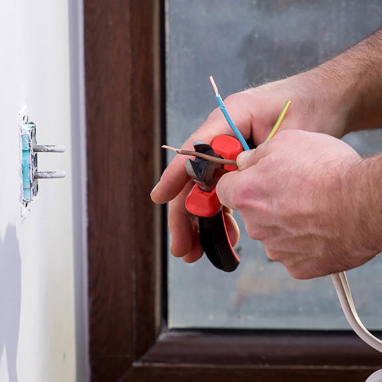 an electrician working on a residential outlet